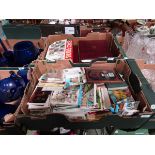 Two trays containing old postcards, stamp albums, etc