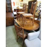 A mid-20th century oak gate leg table with a set of four similar chairs