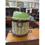 A green glazed ceramic planter together with a wicker basket with metal banding