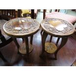 A pair of carved topped circular stools with under tier