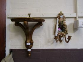 A gilt painted wall mounted shelf together with a mirrored backs gilt painted candle sconce