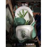 A tray containing green leaf design bowls, platters, etc, supplied through Sainsburys