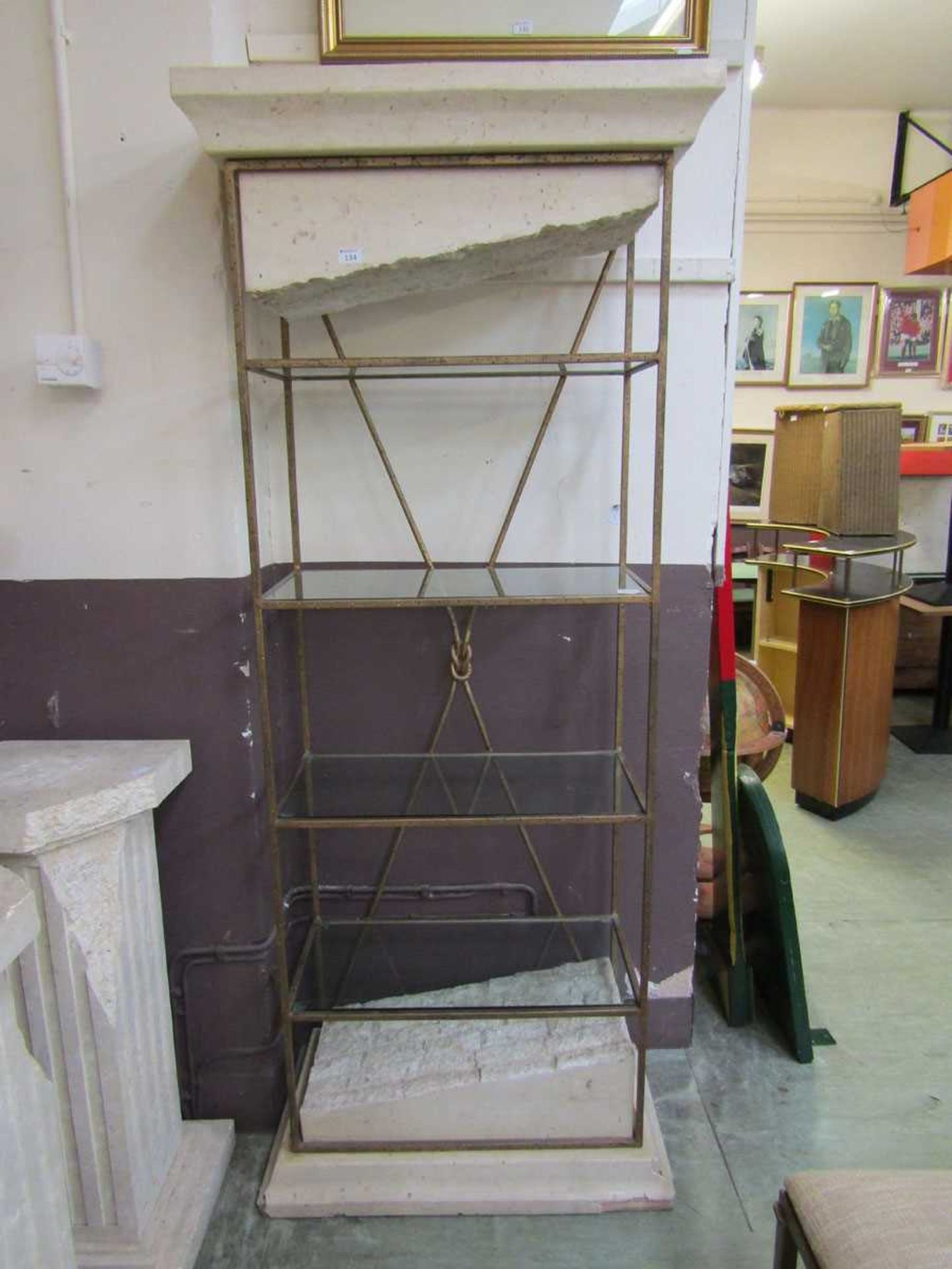 A modern marble effect and metalwork stand with glass shelving, possibly from Harrods in the 1990s