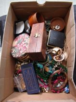 A shoebox containing an assortment of costume jewellery to include beads, bangles, watches, cuff