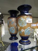 A pair of blue ground Royal Doulton vases with etched gilt and floral decoration