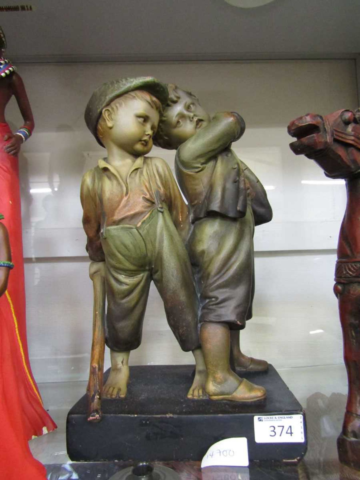 A moulded figural group of two pauper boys on wooden base