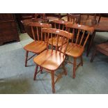 A set of four modern pine dining chairs