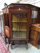 An early 20th century Sheraton revival inlaid glazed display cabinet on square tapering supports