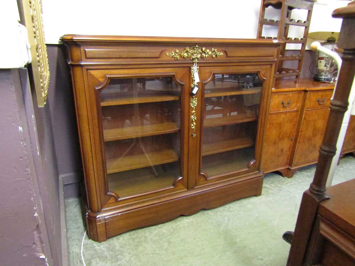 A reproduction cherry wood bookcase incorporating a Sony television