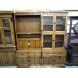 A mid-20th century two section oak cabinet, one cabinet having open storage above bureau style