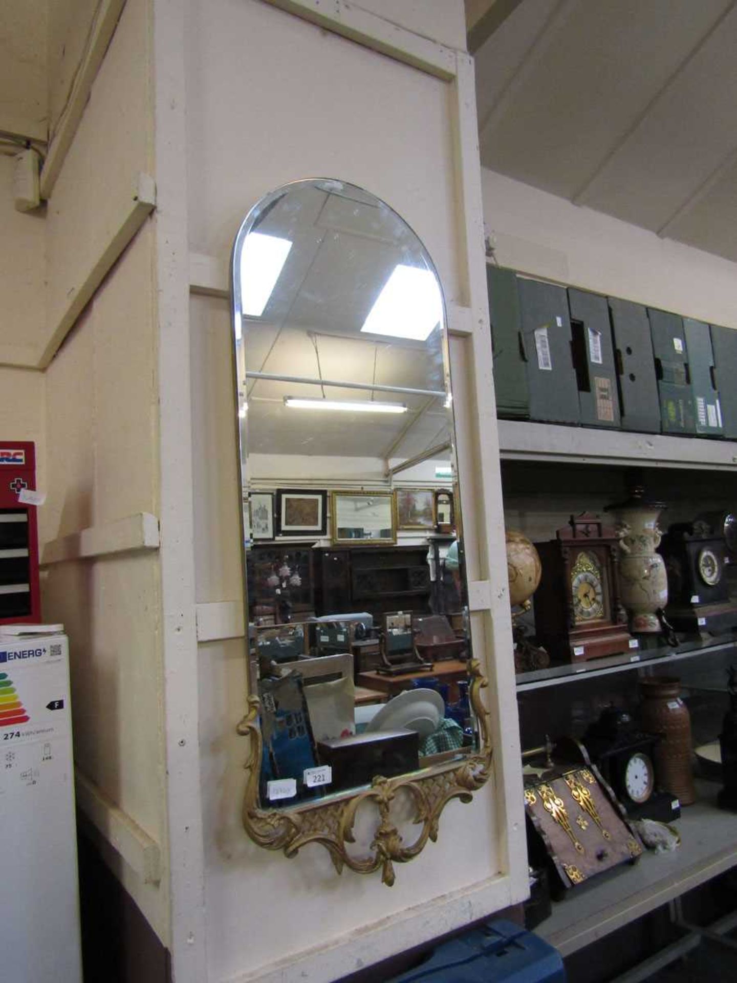 A bevel glass wall mirror with gilt edging to base