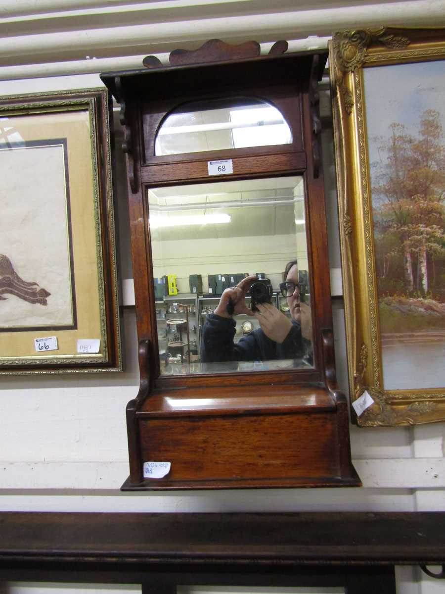 An early 20th century oak wall mounted hall mirror with glove box