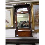 An early 20th century oak wall mounted hall mirror with glove box