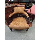 A late Victorian walnut framed tub chair upholstered in a gold coloured cut fabric