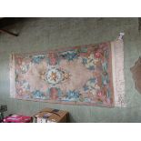 A pink ground rectangular Chinese rug