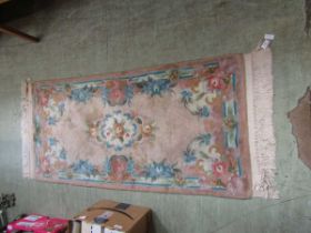 A pink ground rectangular Chinese rug