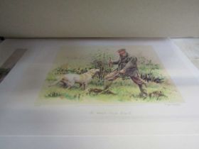 A folio containing a small assortment of mounted prints to include man and dog, hunting scenes,