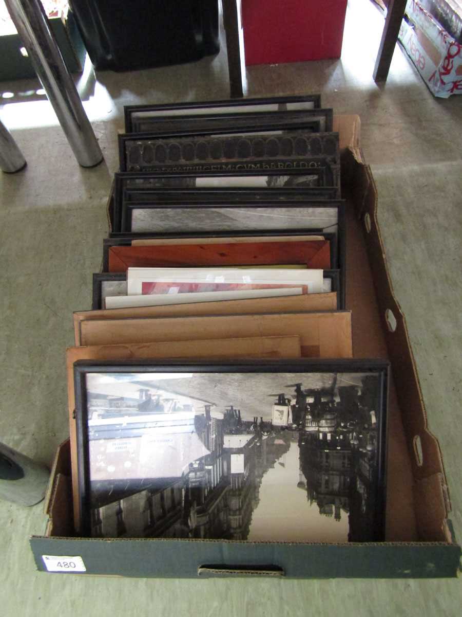 A tray containing an assortment of framed and unframed prints, street scenes, etc