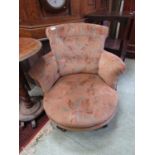 A Victorian mahogany framed tub chair upholstered in a floral button back fabric