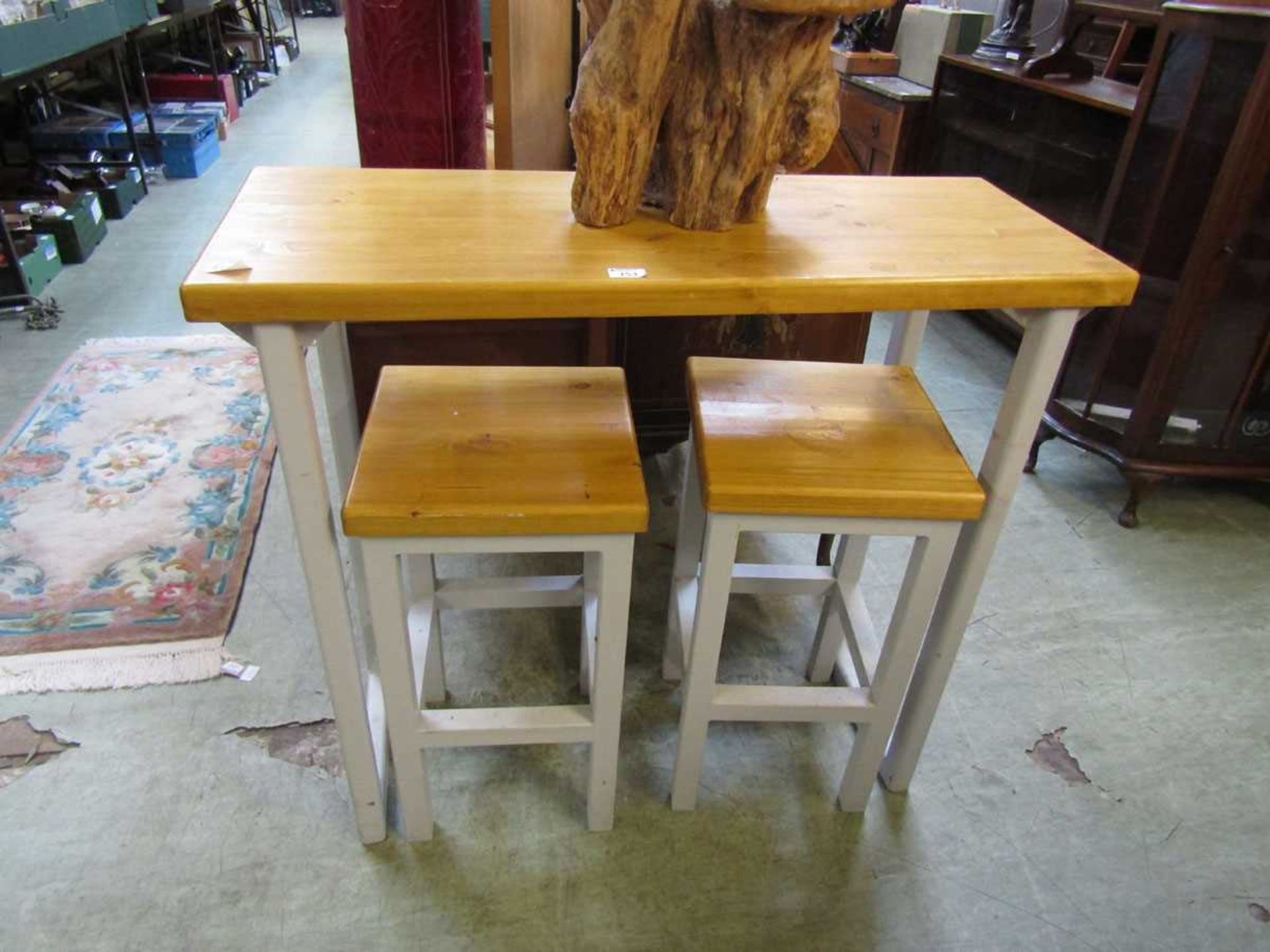 A high pine topped table with a pair of matching stools with cream painted supports