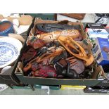 Two trays of reproduction carved wooden eastern masks and figures