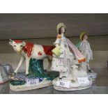 Two Staffordshire flat back figurines of lady and gentleman along with a Staffordshire figure of a