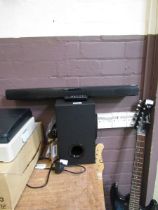An LG soundbar with remote and subwoofer