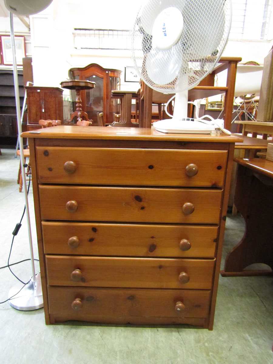 A modern pine chest of five drawers