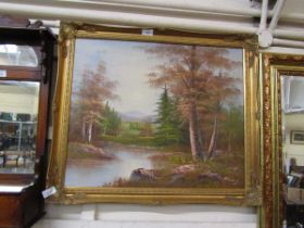 A modern gilt framed oil on canvas of river running through wooded scene, signed bottom right Barry