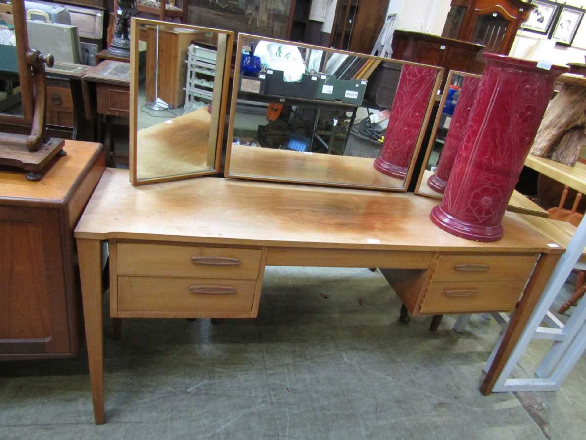 A mid-20th century teak dressing table with a triple mirror to back, with a pair of drawers by