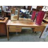 A mid-20th century teak dressing table with a triple mirror to back, with a pair of drawers by