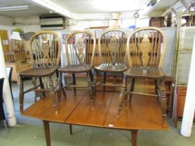 A set of four early 20th century wheel back dining chairs