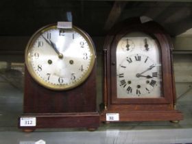 A mahogany cased dome top mantel clock along with an oak cased dome top mantel clock on brass bun