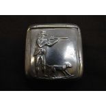 A white metal snuff box with embossed shooting scene with gun dog