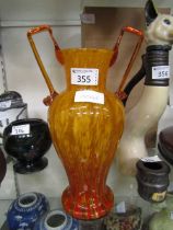 A Murano/Scheider style twin handled tango orange glass vase