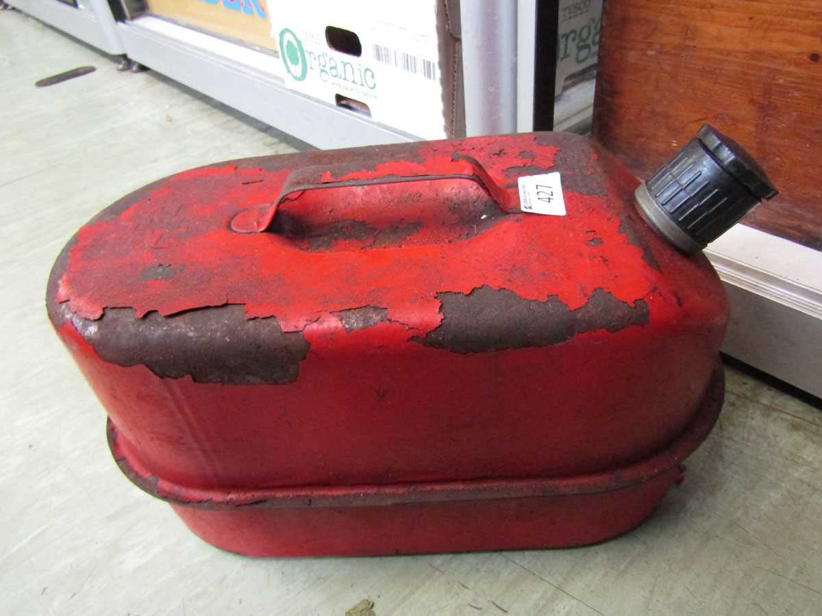 A red painted metalwork petrol can