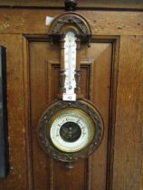 A carved walnut early 20th century banjo barometer.