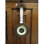 A carved walnut early 20th century banjo barometer.