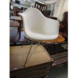 An Eames style white Perspex chair on chrome base