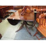 A reproduction mahogany pedestal drop leaf table