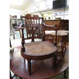 A Victorian mahogany bergere seated open armchair