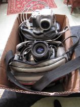 A box containing a cased Canon Eos-650 camera and a cased Fujifilm S-304 Finepix camera