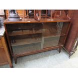 A mid-20th century oak bookcase with two sliding glazed doors