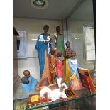 An assortment of eight moulded figures and figural groups of African people, animals, etc