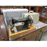 A cased Singer manual sewing machine