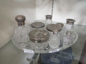 A cut glass tray along with nine glass vessels with some silver plated and some silver hallmarked