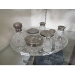 A cut glass tray along with nine glass vessels with some silver plated and some silver hallmarked