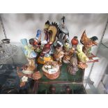 A large assortment of ceramic figurines of birds by various makers