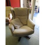 A mid-20th century swivel chair upholstered in a cream wool fabric