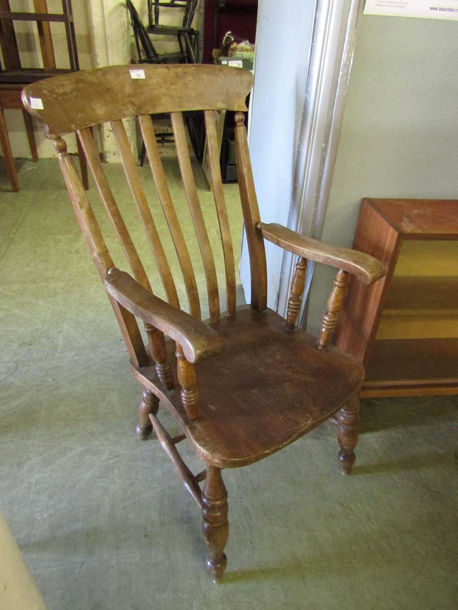 An early 20th century lathe back elbow chair